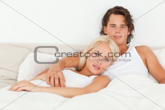 Serene couple lying on a bed