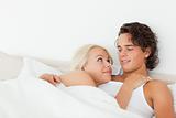 Couple lying on a bed hugging