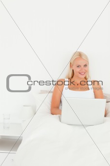 Portrait of a blonde woman with a laptop