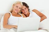 Couple watching a movie with a laptop