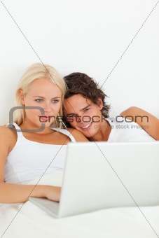 Portrait of a couple watching a movie with a laptop