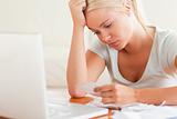 Stressed blond woman doing paperwork