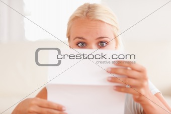 Shocked woman reading a letter