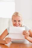Grinning woman holding a letter