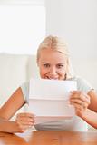 Smiling woman reading a letter