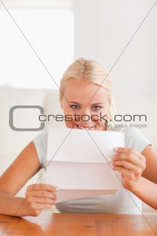 Smiling woman reading a letter