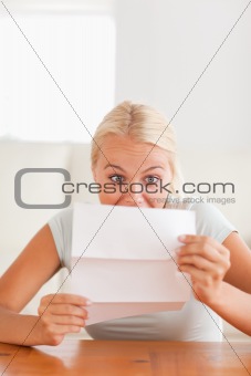 Woman looking at a letter in disbelief