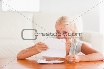 Happy woman reading a letter