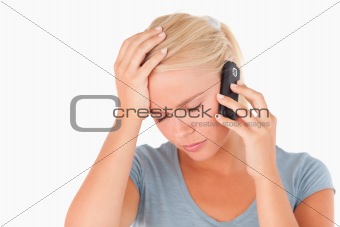 Sad blond woman on a phone