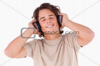 Smiling man with headphones having eyes closed