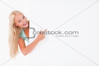 Joyful gorgeous woman pointing at a whiteboard
