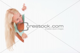 Blond Woman smiling at a whiteboard