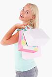 Joyful blond woman with shopping bags