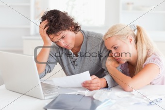 Tired couple doing their accounts