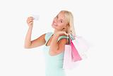 Smiling woman with a credit card and bags