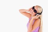Charming woman with earphones and sunglasses