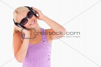 Glorious woman with earphones and sunglasses