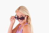 Blond lady peeking over her sunglasses