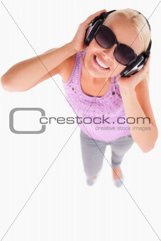 Smiling lady with sunglasses and earphones