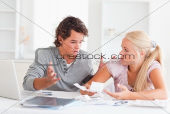 Couple with bills and a laptop