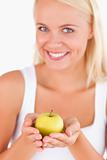 Charming blond woman holding an apple