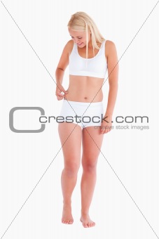 Portrait of a thin woman gripping her waist