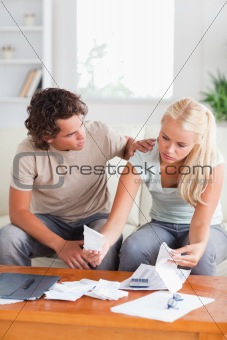 Man comforting his wife while accounting