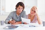 worried couple listing expenses