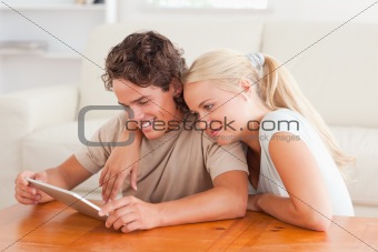 Hugging couple with a tablet