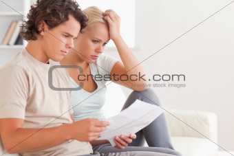 Despaired couple reading letters