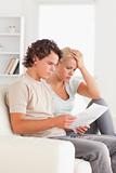Unhappy couple reading letters