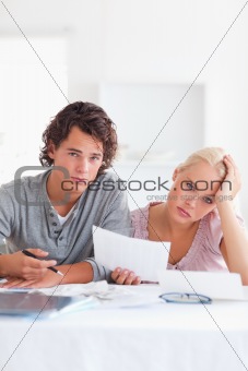 Unhappy couple reading a letter
