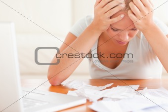 Worried blond woman accounting