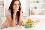 Woman telephoning in kitchen