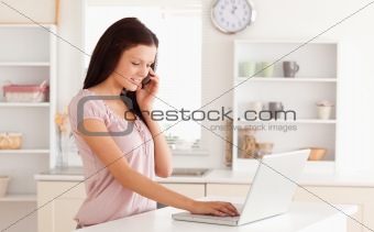 Woman telephoning and typing