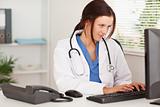 Female doctor typing on keyboard