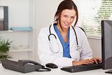 Smiling female doctor typing