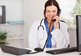 Female doctor telephoning
