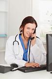 Female doctor telephoning and looking