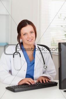 Female doctor typing 