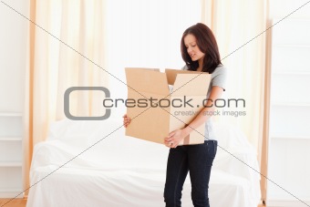 A woman carrying a cardboard