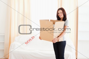 Woman holding full cardboard