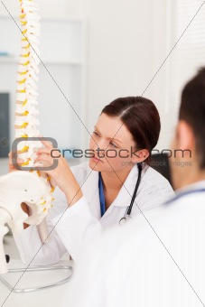 Female doctor touching a spine