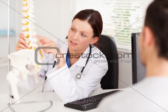Female doctor pointing on a bone