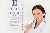 Pretty female optician and eye test