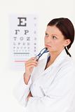 Beautiful female optician with eye test