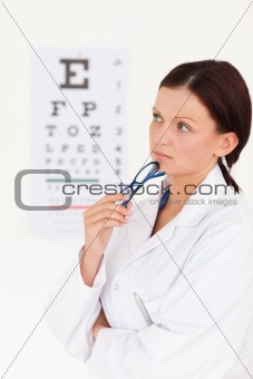 Beautiful female optician with eye test