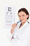 Gorgeous female optician with an eye test