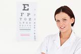 Nice female optician with eye test