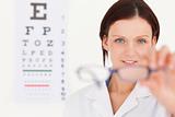 Female optician showing glasses